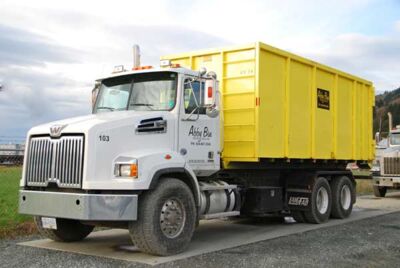 Abby Bin truck yellow roll off bin